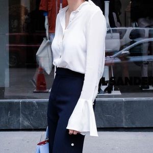 Elegant white blouse with pearl button